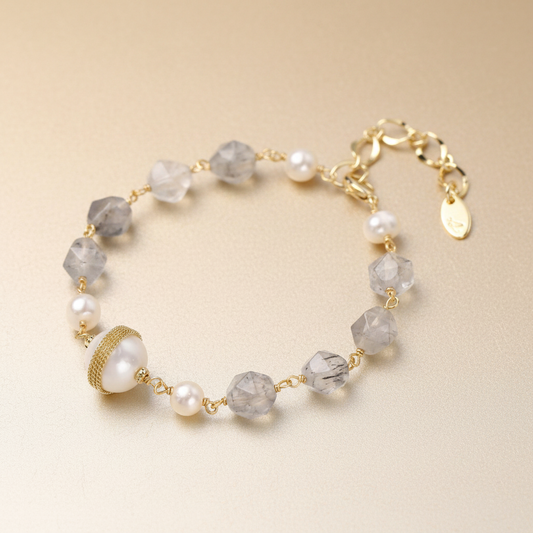 Baroque pearl and quartz bracelet, 14K gold-plated Eco-brass by flyliving, featuring faceted grey quartz, freshwater pearls, and a central mesh-wrapped large pearl.