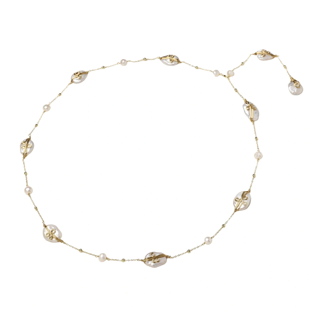 Long gold chain necklace with baroque pearls wrapped in leaf designs and small freshwater pearls spaced along the strand