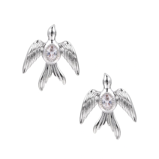 White gold-plated bird earrings with spread wings and oval zirconia center on cream background