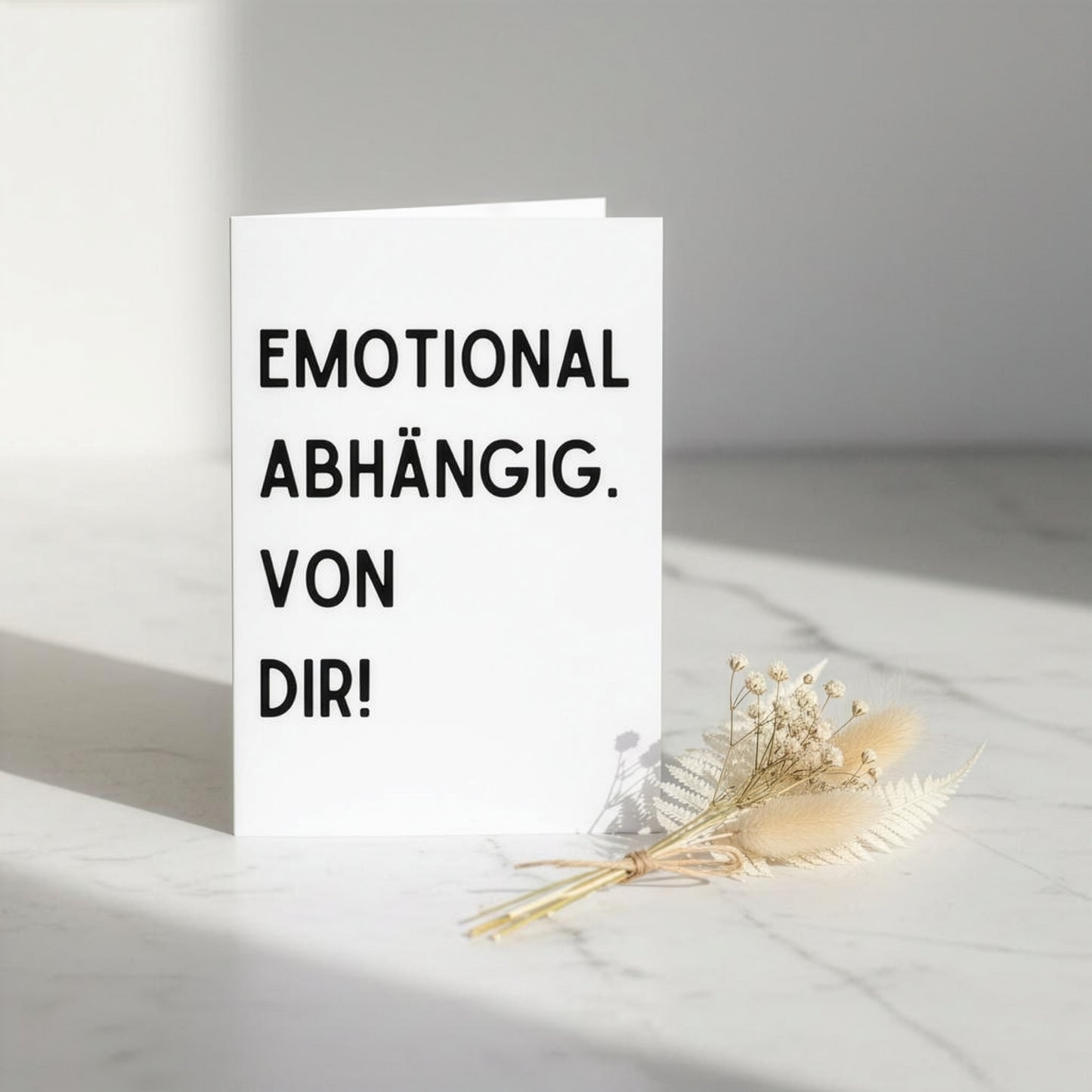 Minimalistische weiße karte emotional abhängig mit schwarzem text und umschlag für persönliche botschaften