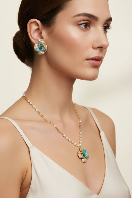 14K gold-plated jewelry set by flyliving, featuring flower-shaped earrings and a pearl necklace with a matching pendant.
