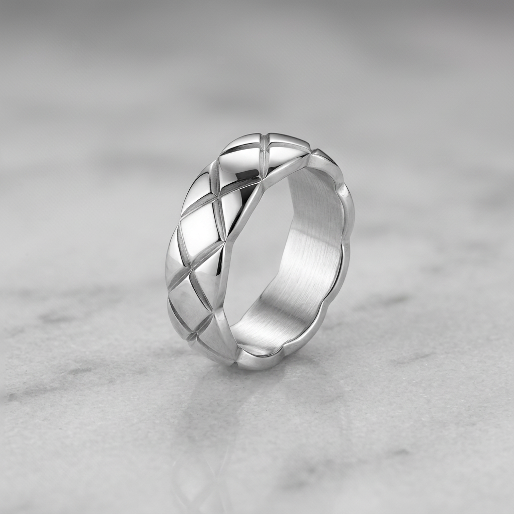 Polished stainless steel band ring by flyliving with a geometric quilted pattern and brushed interior.
