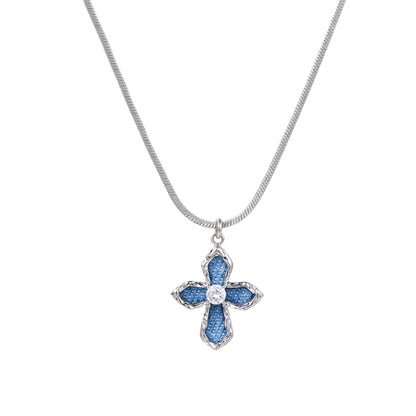 White gold plated cross pendant with blue denim fabric inlays and central zirconia crystal on adjustable chain