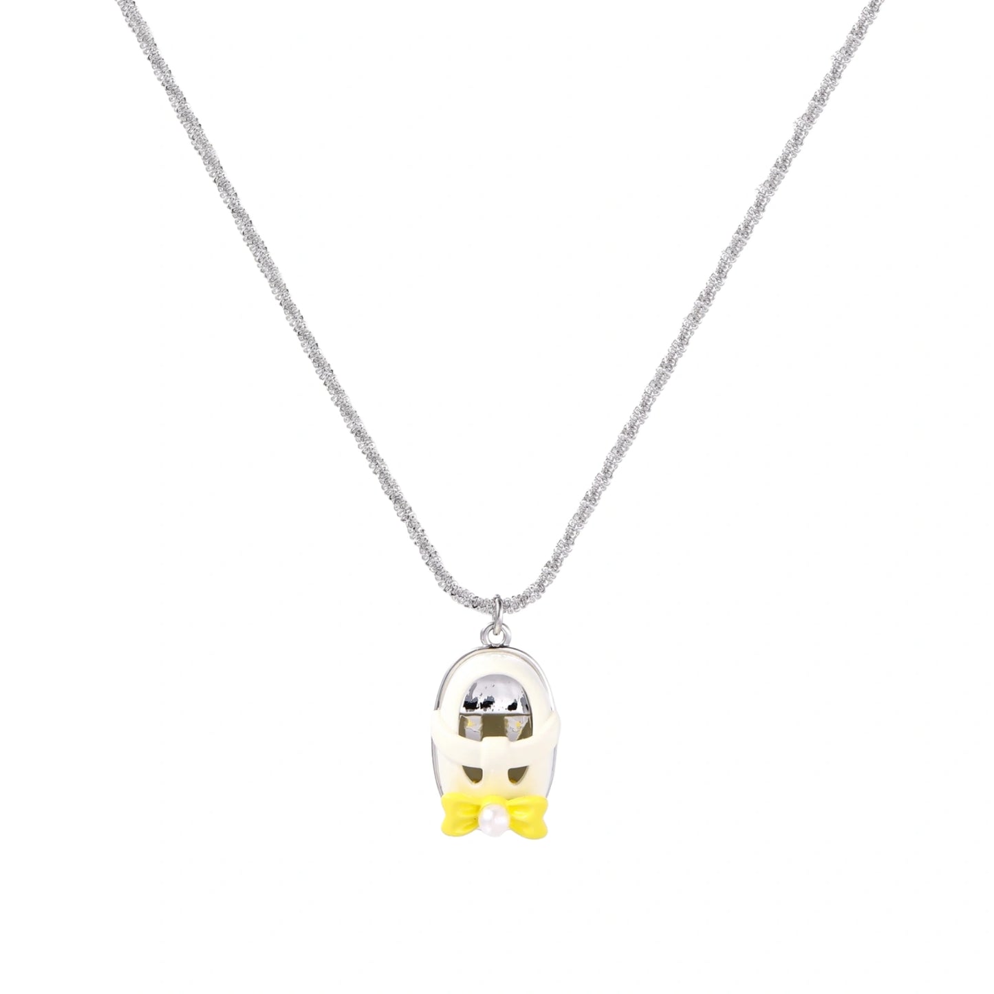Chrome egg-shaped pendant with kawaii face, yellow bow, and pearl detail on silver chain against white background