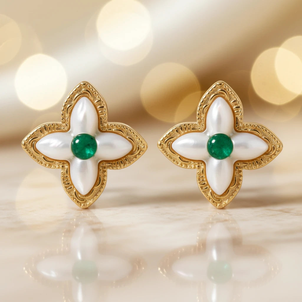 Vergoldete Glücks-Kleeblatt Ohrringe von flyliving, mit weißen Details und grünen Edelsteinen in der Mitte.