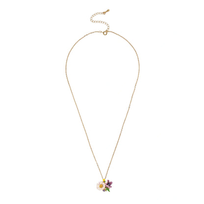 Gold-plated necklace with pink and purple enamel flower pendant featuring crystal accents on cream background