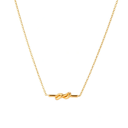 Dainty 18K gold plated necklace with infinity knot pendant on delicate chain against white background