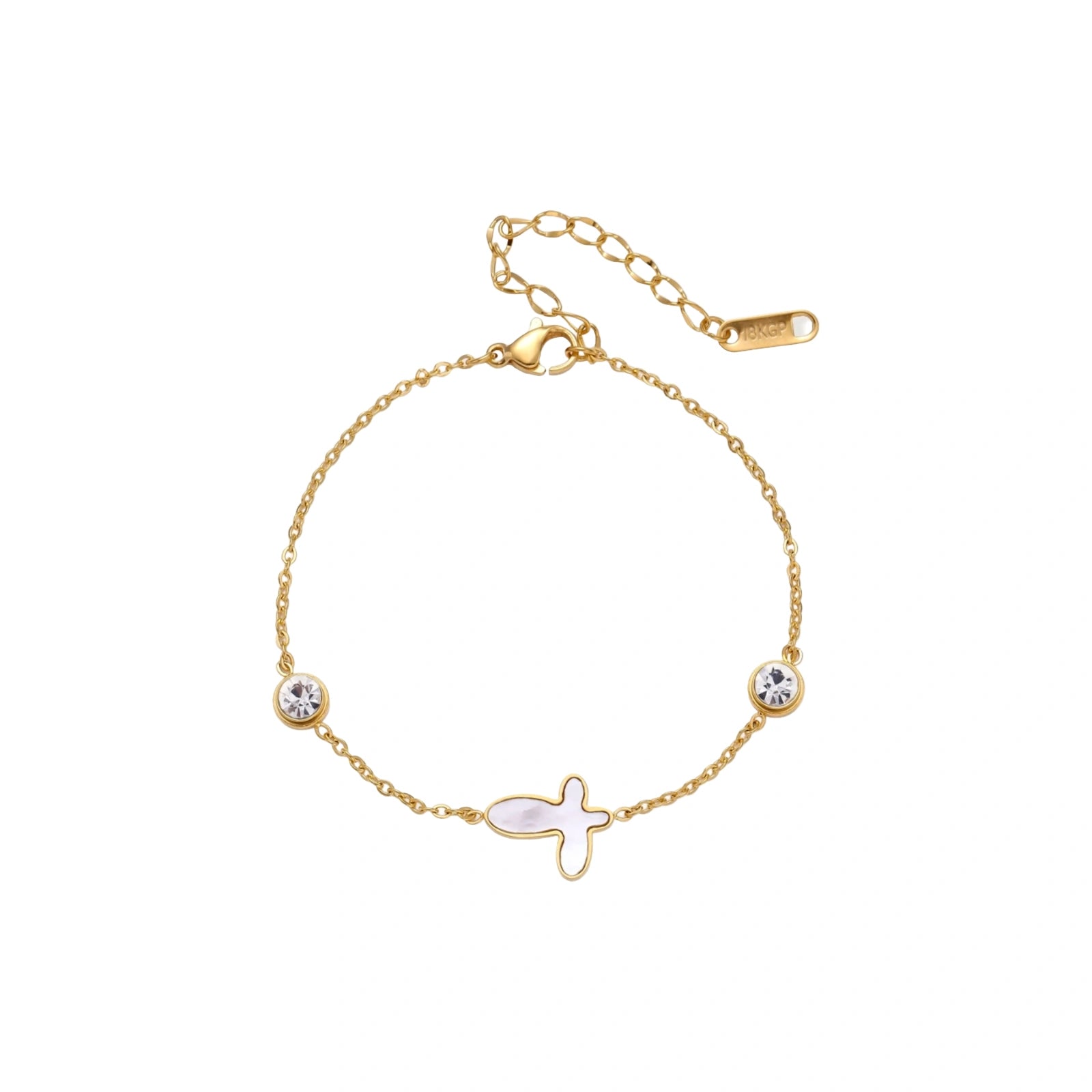Gold chain bracelet with white mother of pearl butterfly pendant and two bezel-set crystals on cream background