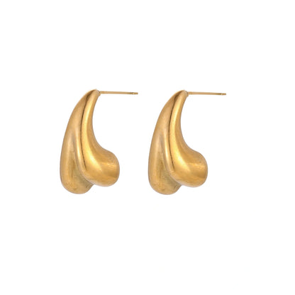Organic sculptural gold stud earrings with fluid matte finish on cream background