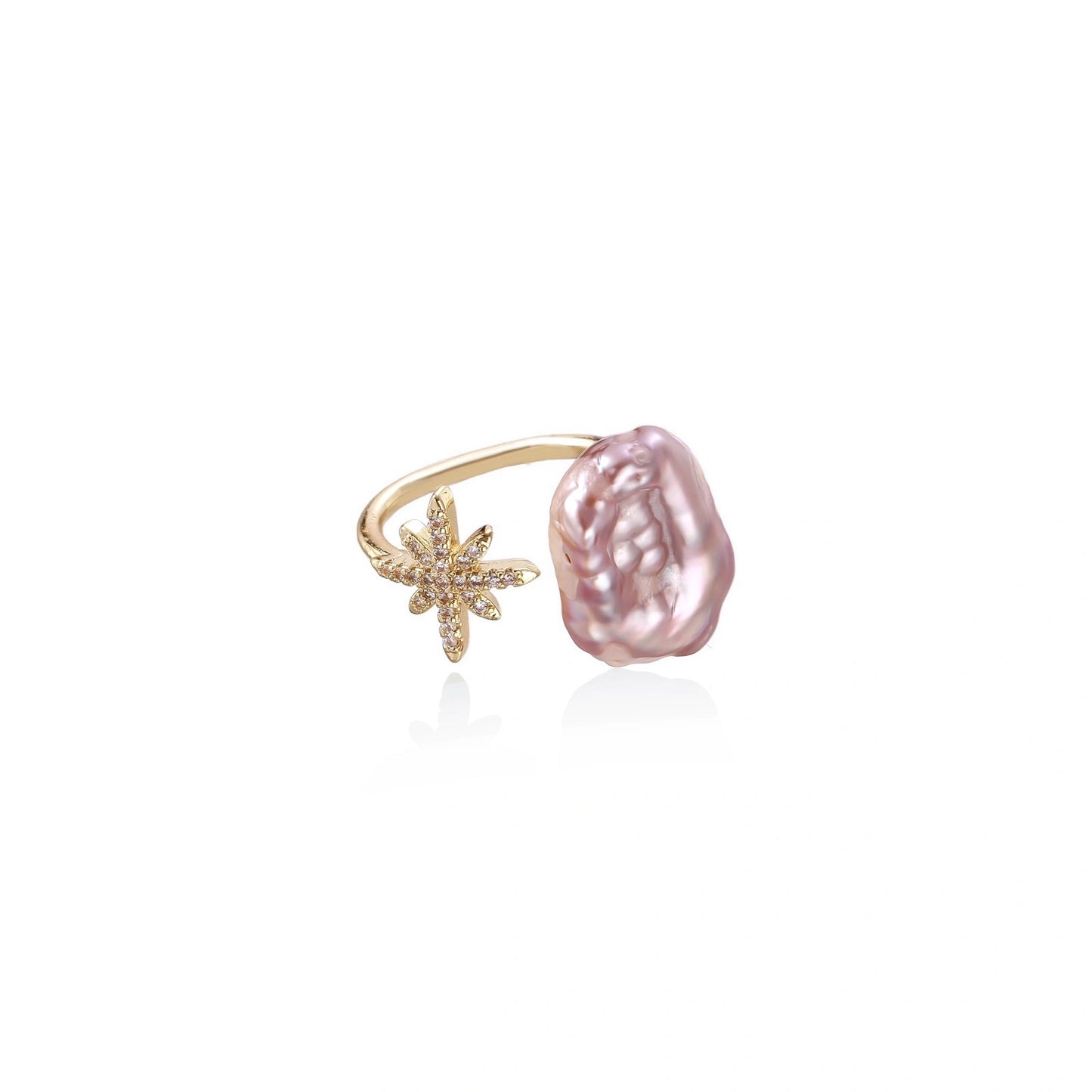 Eine goldene ring mit funkelndem sternenförmigem akzent und unregelmäßig geformter rosa perle sternenklare perlenträume