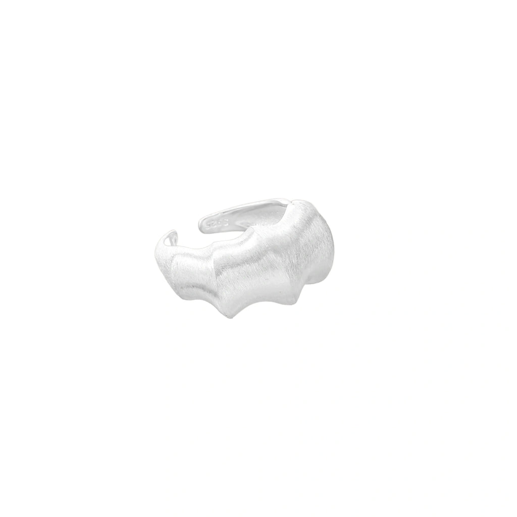 Brushed sterling silver ring with organic wave-like edges and adjustable cuff design on white background