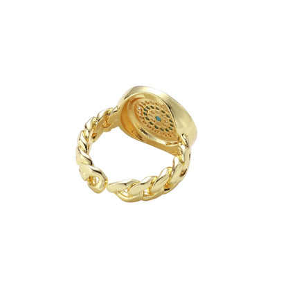Gold chain ring with Greek key border and turquoise evil eye center on white background