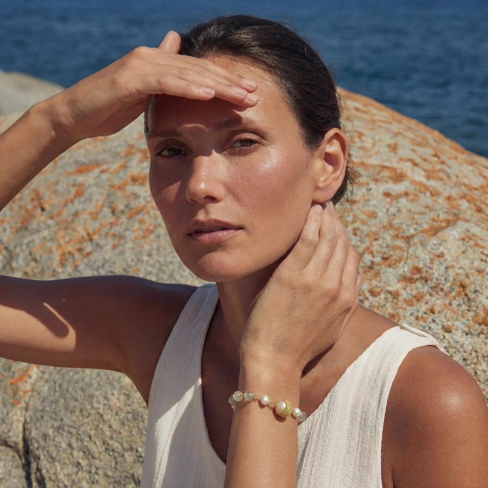 Baroque pearl bracelet by flyliving with 14K gold-plated Eco-brass, quartz, and freshwater pearls, on a woman's wrist.