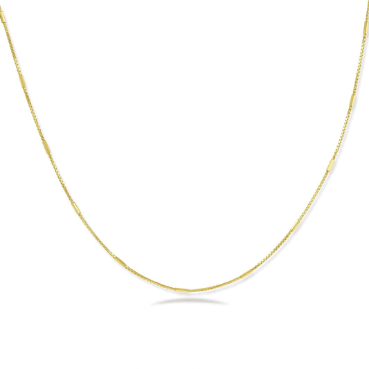 Delicate gold-plated sterling silver chain necklace with geometric segments displayed against cream background