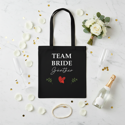 Personalisierter schwarzer canvas jga jutebeutel mit weißem team bride schriftzug und roten herzen für braut und team