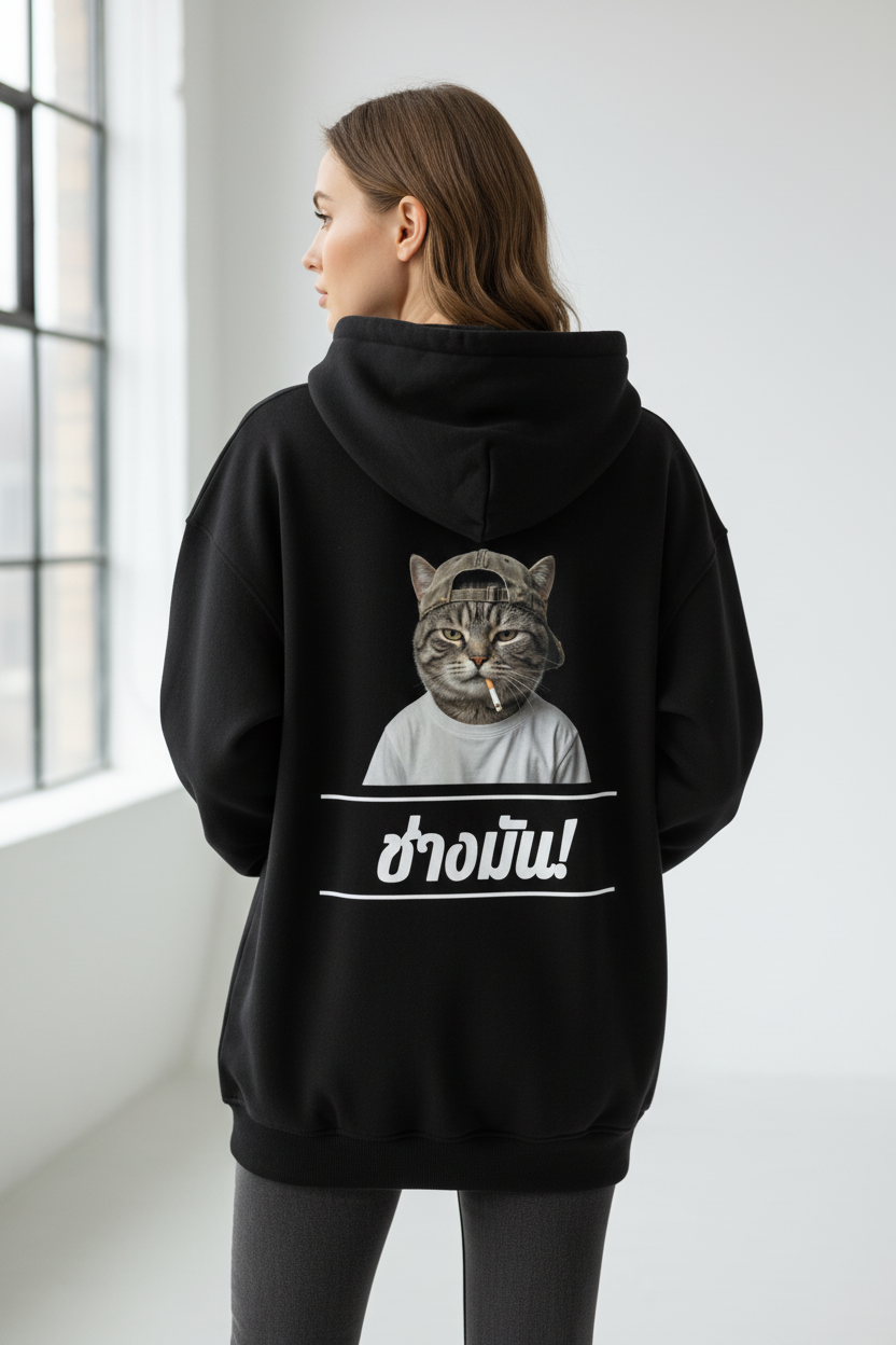 Black oversized hoodie by flyliving, featuring a cool cat smoking graphic and Thai text 'ช่างมัน!' meaning 'Fuck It', worn from the back.