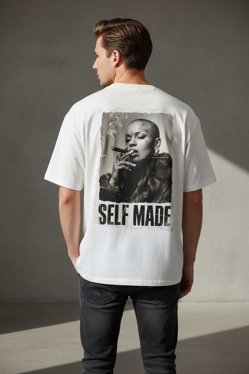 White oversized t-shirt by flyliving with a 'SELF MADE' Boss Lady print featuring a bald woman smoking a cigar, worn from the back.