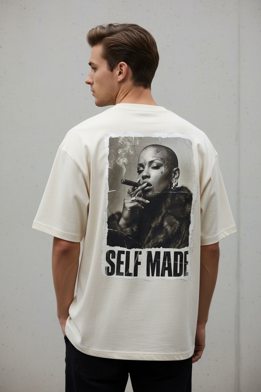 Oversized cream T-shirt by flyliving with a 'self made' Boss Lady print on the back, worn by a man from the back.