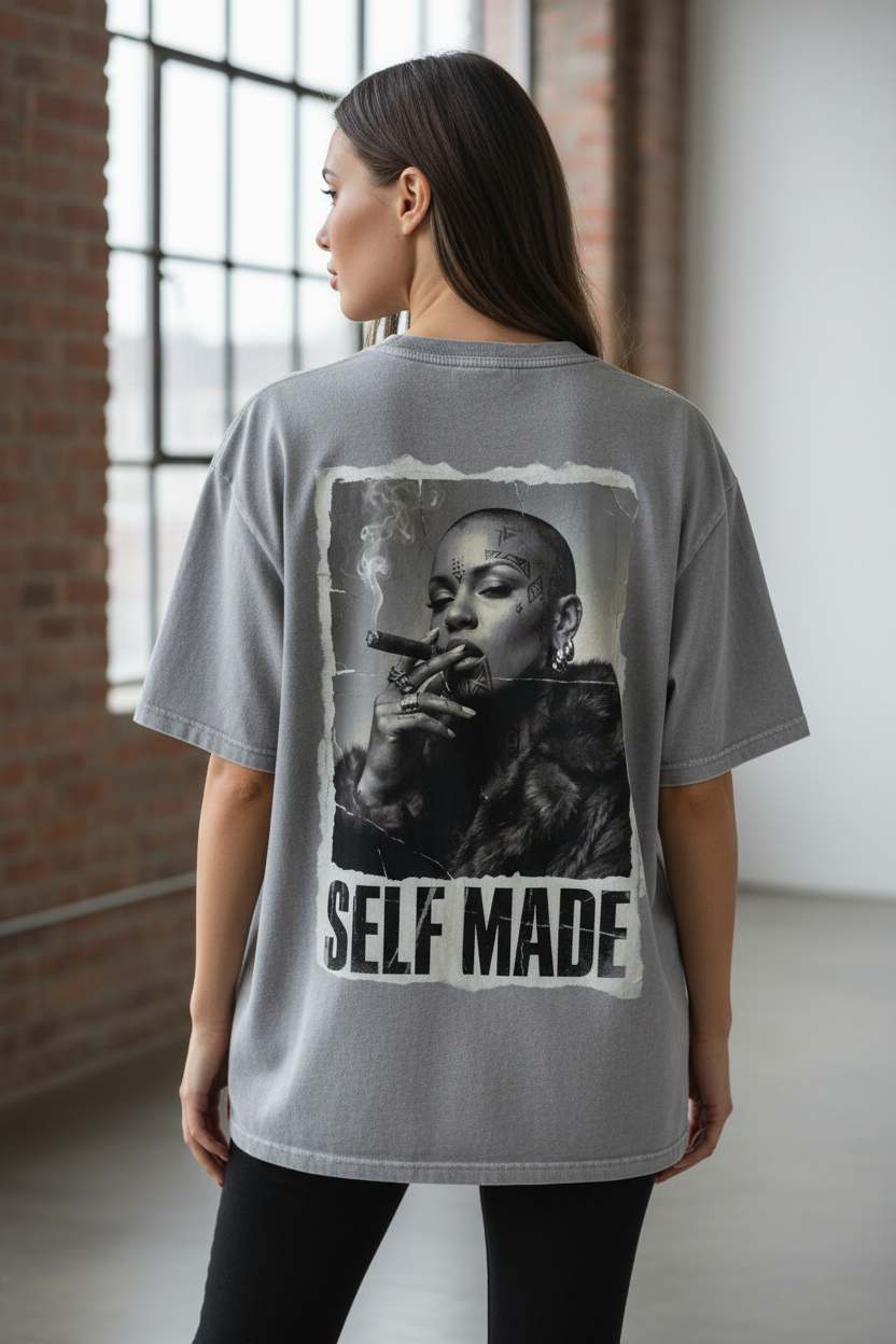 Grey oversized t-shirt by flyliving featuring a "Boss Lady" print of a woman smoking a cigar and "SELF MADE" text on the back.