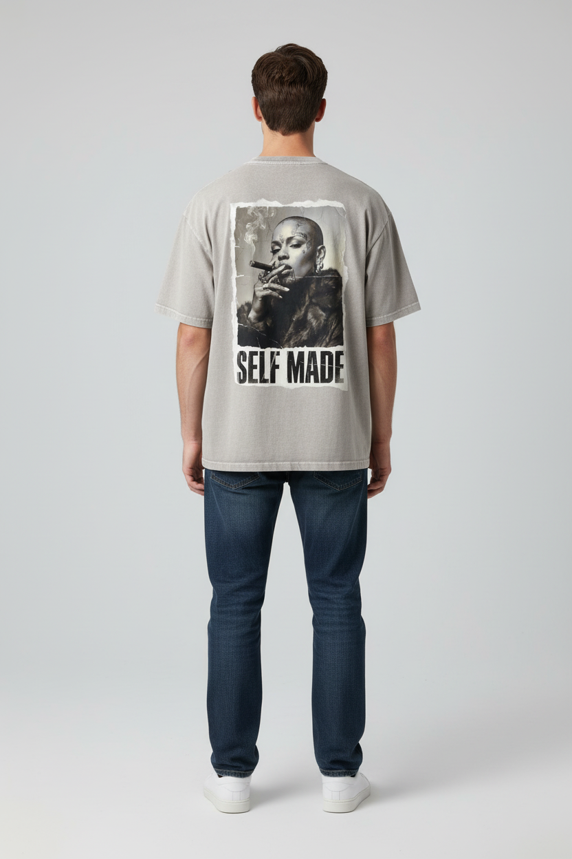 Light grey oversized T-shirt by flyliving featuring a print of a bald woman smoking a cigar and 'SELF MADE' text on the back.
