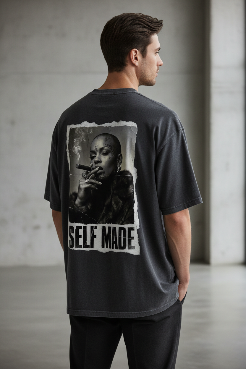Dark grey oversized T-shirt by flyliving, featuring a distressed back 'Boss Lady' print with 'SELF MADE' text, worn from the back.