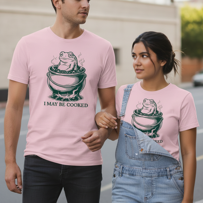 Pink kurzarmshirt mit grünem frosch im dampfenden kessel und text i may be cooked sarkastisches humor design