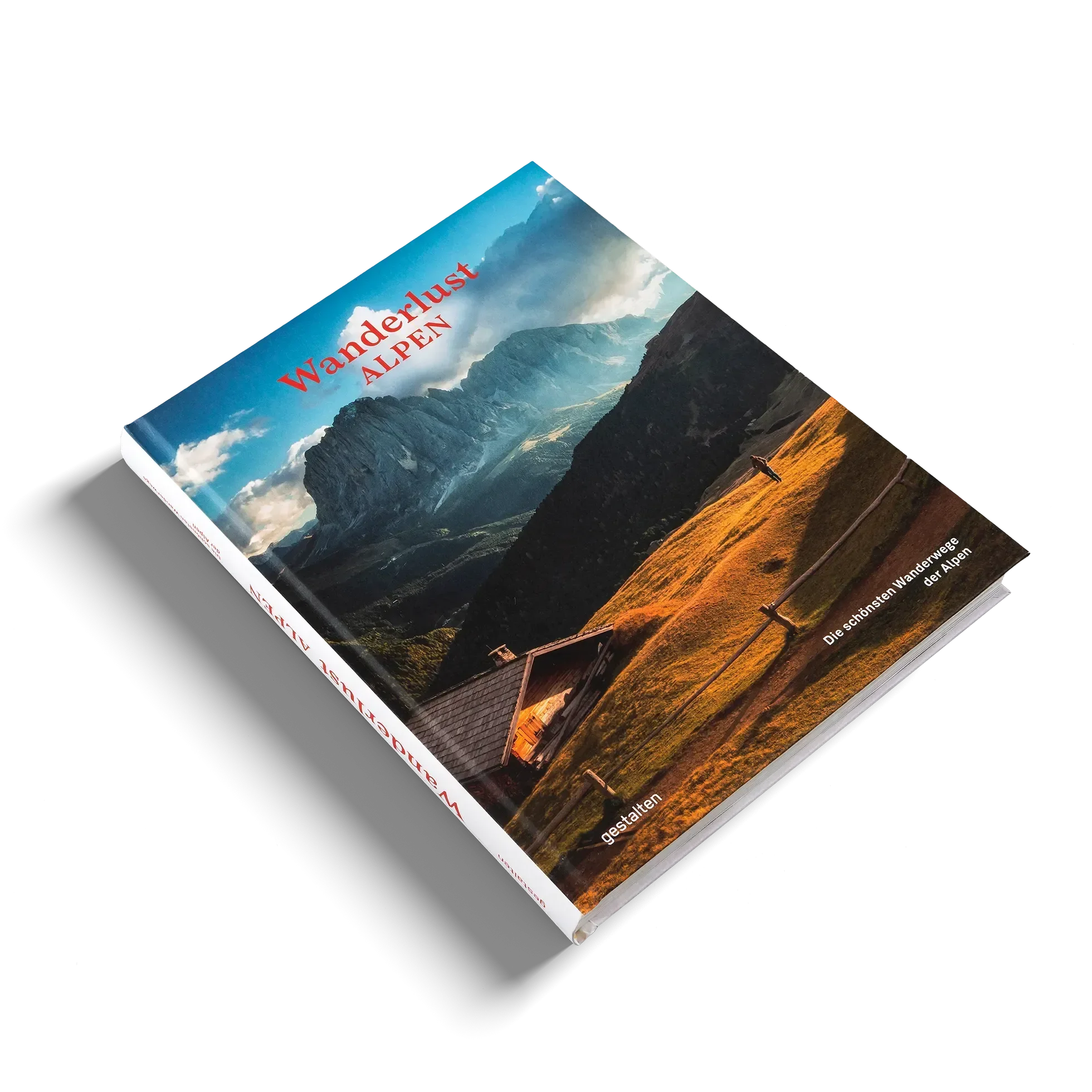Das Buch "Wanderlust Alpen" von gestalten EU Shop liegt auf einer weißen Fläche und zeigt auf dem Cover eine Holzhütte inmitten goldener Hügel - ein Aufruf zu alpinen Abenteuern mit dramatischen Bergen und Wolken im Hintergrund.