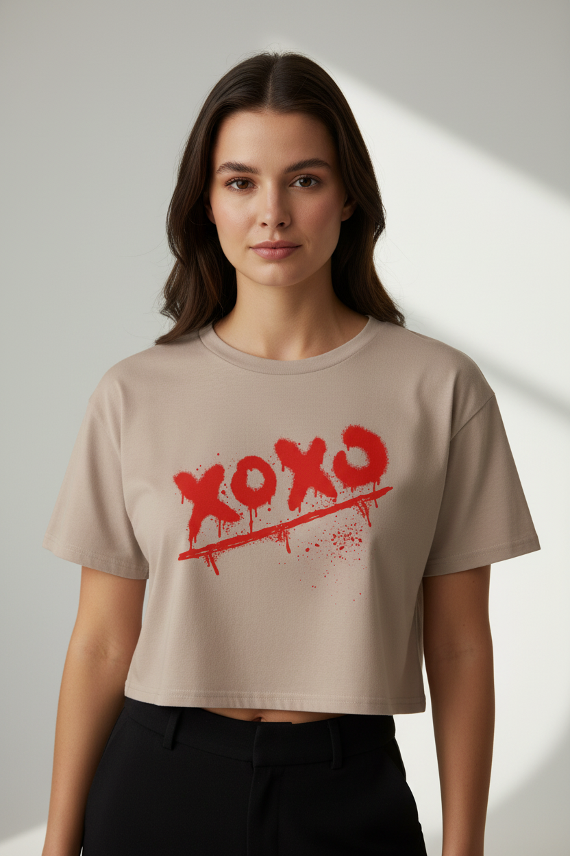 Beige 100% combed cotton relaxed fit Crop-Top by flyliving, with a red spray-painted 'xoxo' graphic, crossed out with drips and splatters.