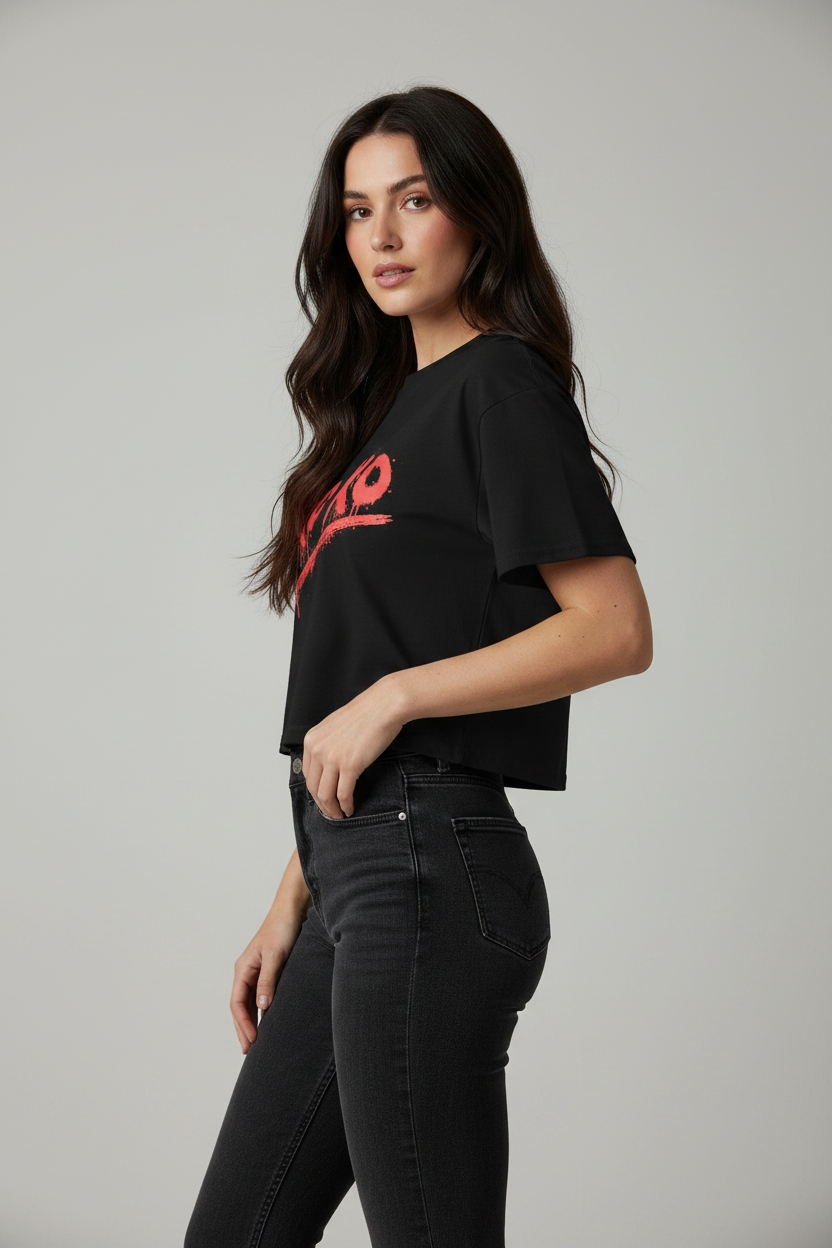 Black relaxed fit crop top by flyliving with a red 'xoxo' graphic, worn by a woman in dark wash jeans.