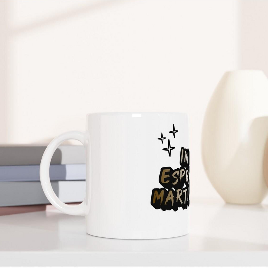 White ceramic mug by flyliving featuring 'In my espresso martini era' text and sparkle graphics, presented in a side view.