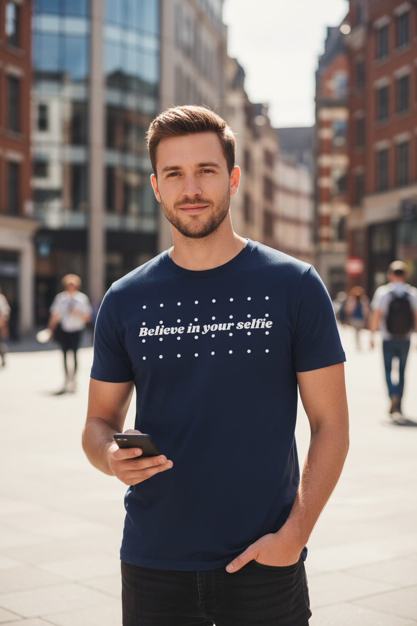 Navy blue cotton T-shirt by flyliving featuring "Believe in your selfie" text and white dots, worn by a man.