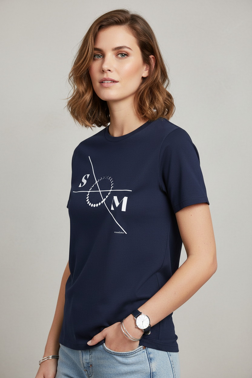Navy blue cotton T-shirt by flyliving featuring a white moon phases graphic with S and M letters, worn by a woman in light wash jeans and a watch.