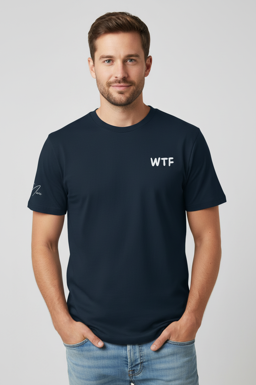 Unisex dark blue t-shirt by flyliving with a 'WTF' retro comic graphic on the chest and a signature on the left sleeve, worn with jeans.