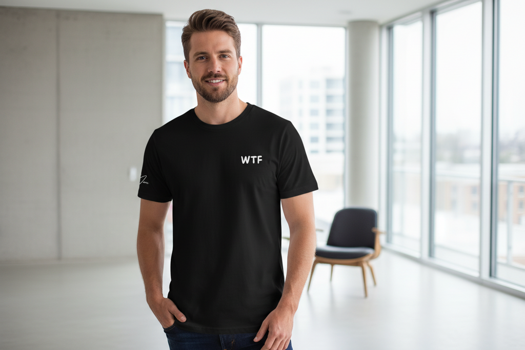 Black Unisex T-Shirt with a retro comic graphic print by flyliving, featuring 'WTF' on the chest and a sleeve logo, worn by a man.